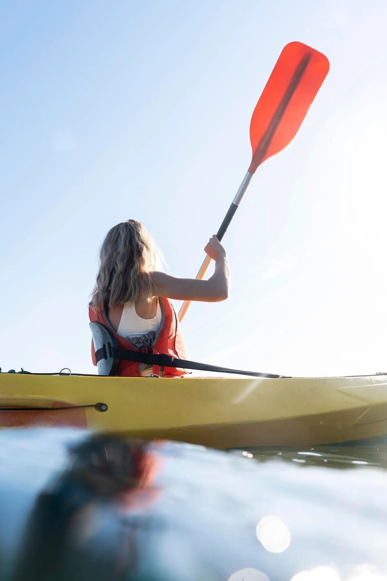 A beautiful young woman traveling by canoe