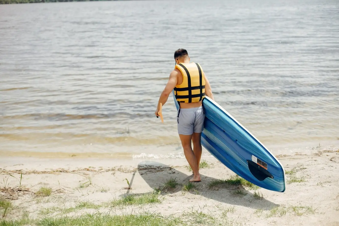 A surfer on a beach in summer
